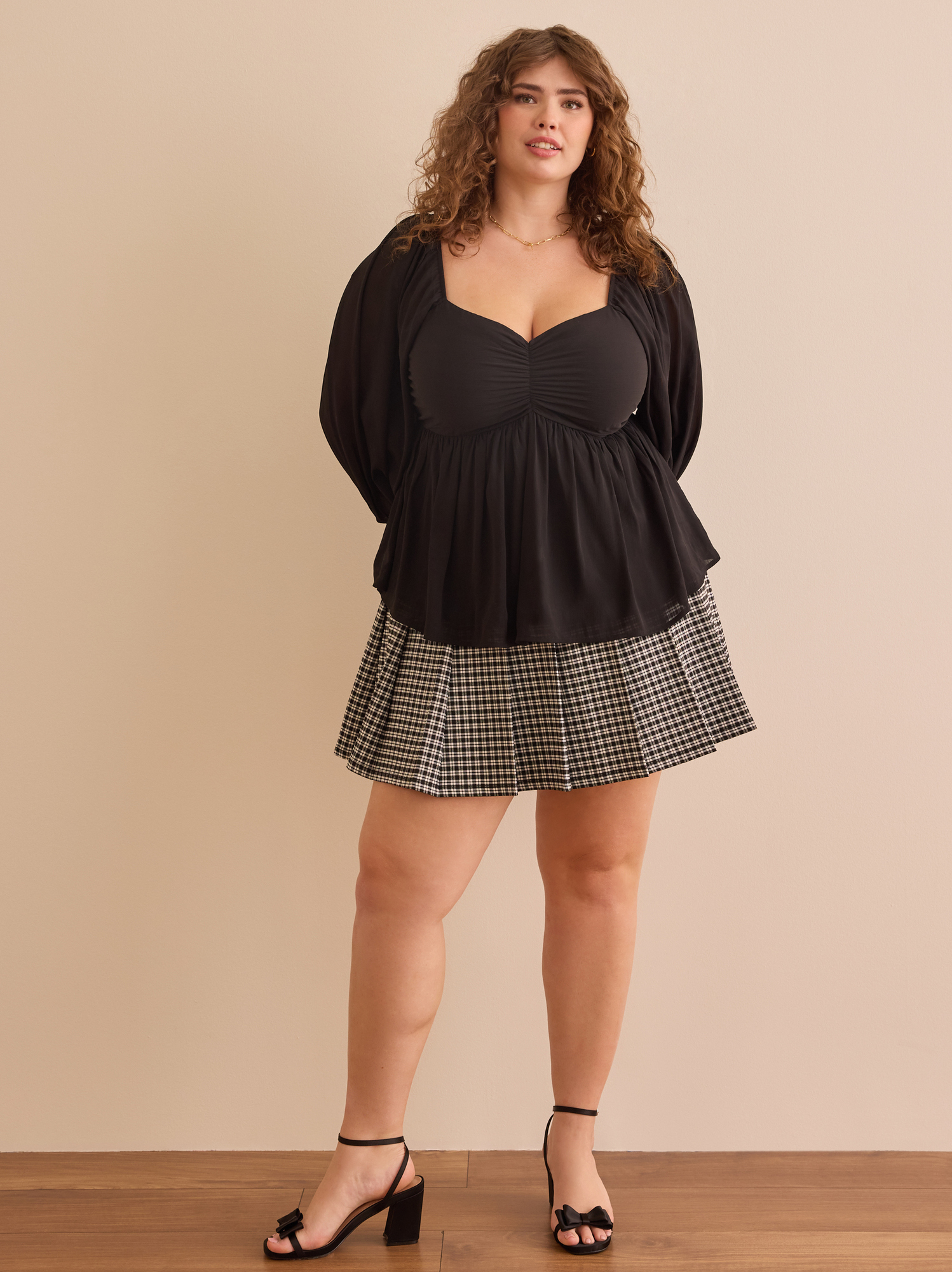 Brynnlee Peplum Top in Black Arula